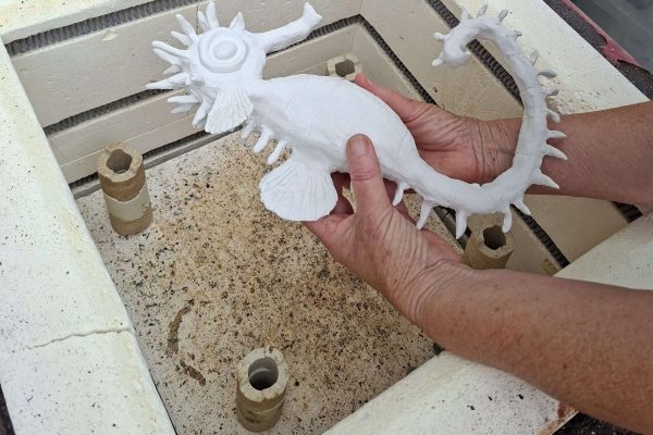 Monica Fergus - gently taking the bisque fired piece out of the kiln